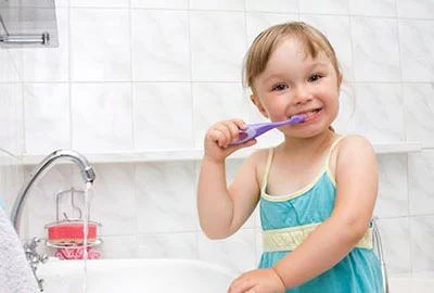 child brushing their teeth at the dentist