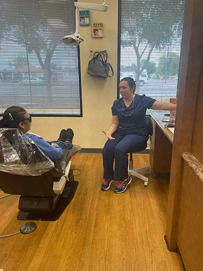 Dr. Teiman showing a patient her dental x-rays during a preventive dental checkup
