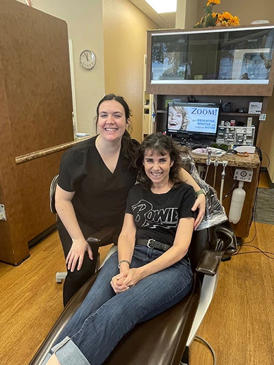 patient smiling with dentist after discussing comfort dentistry options before her procedure