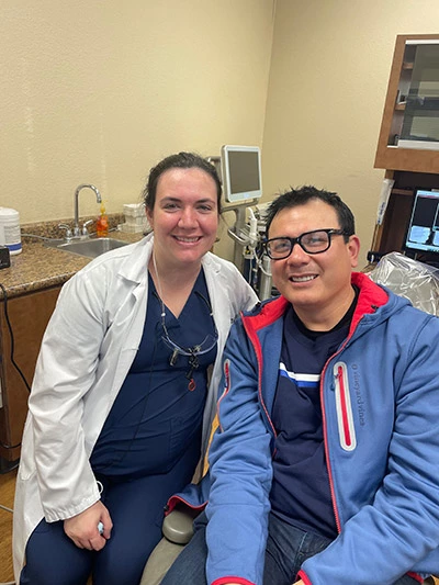 Dr. Jessica Teiman, DMD smiling with one of her patients